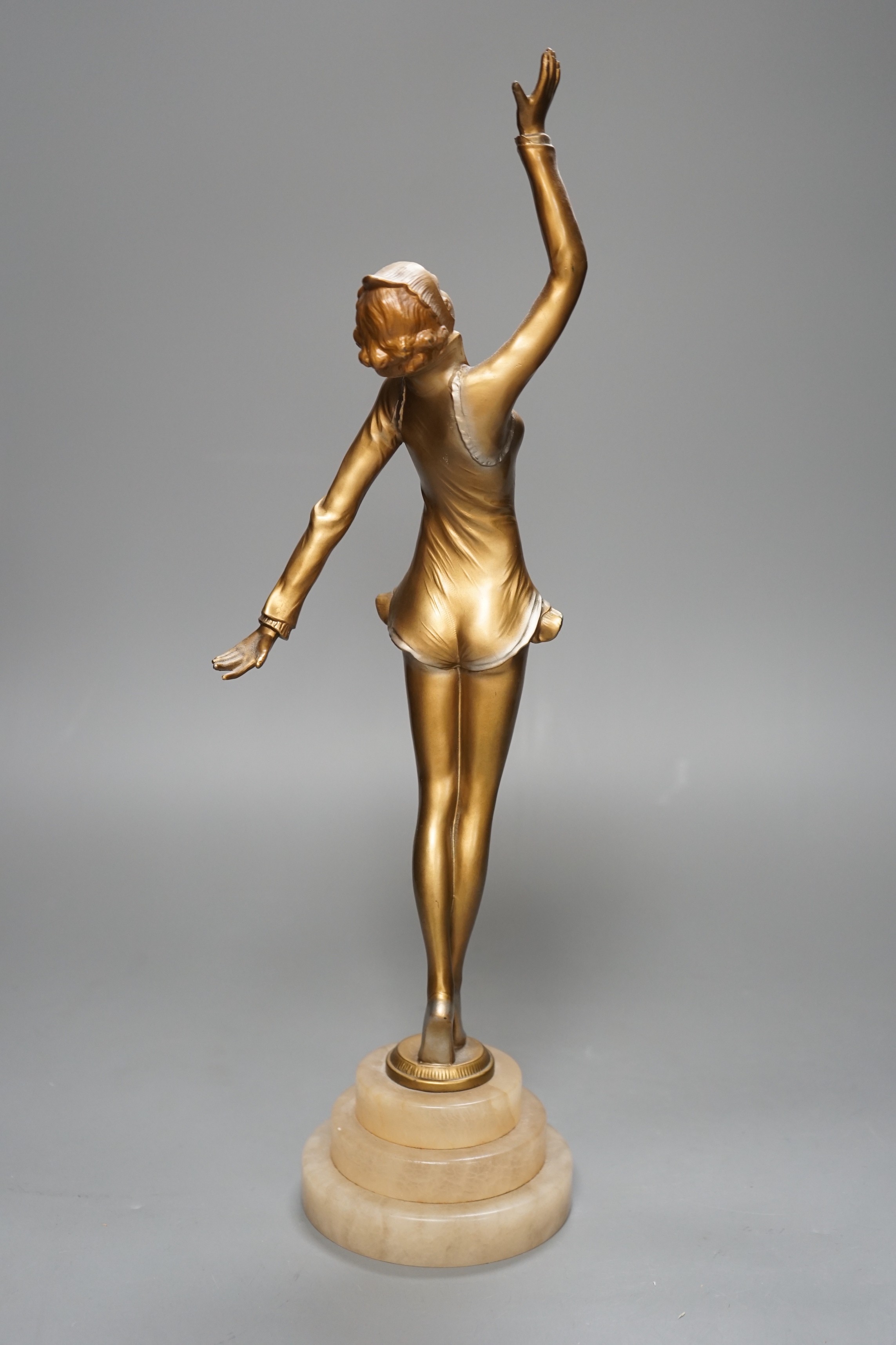 An Art Deco gilt metal model of a dancer, on stepped alabaster base, 41cm